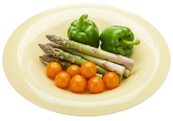 Isolated plate of green bell peppers asparagus and physalis groundcherries fresh food