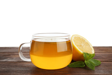 Aromatic tea in cup with lemon and mint on wooden table against white background