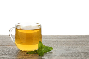 Aromatic tea with lemon in cup and mint on wooden table against white background, space for text
