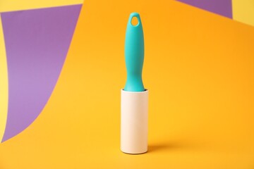 Fototapeta premium One sticky lint roller on color background
