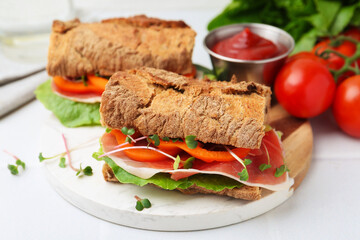 Tasty ciabatta sandwiches served on white table, closeup