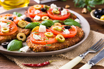 Breaded pork chop in tomatoes. Served with olives and feta cheese.