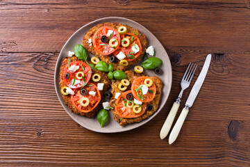 Breaded pork chop in tomatoes. Served with olives and feta cheese.