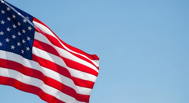 American Flag Waving Against Blue Sky Honoring Veterans Day and Patriotism - Powered by Adobe