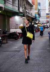 Fashion shoot with a professional model in an Asian city in stylish clothes.