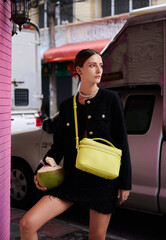 Fashion shoot with a professional model in an Asian city in stylish clothes.