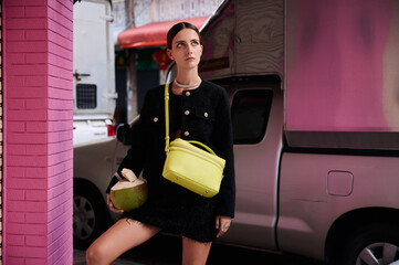 Fashion shoot with a professional model in an Asian city in stylish clothes.