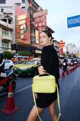 Fashion shoot with a professional model in an Asian city in stylish clothes.
