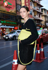 Fashion shoot with a professional model in an Asian city in stylish clothes.