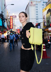 Fashion shoot with a professional model in an Asian city in stylish clothes.
