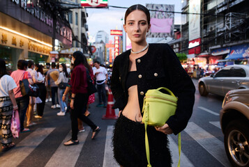 Fashion shoot with a professional model in an Asian city in stylish clothes.