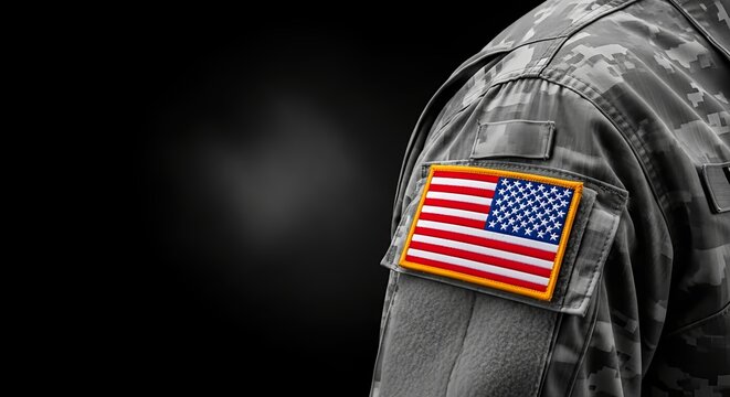 Patriotic tribute on Veterans Day showing an American flag patch on a military camouflage uniform. copy space empty  - Powered by Adobe