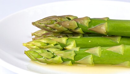 Close-up of fresh asparagus spears on a white plate
