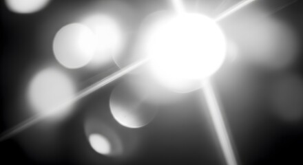 Abstract black and white bokeh background with bright light flares, creating a dreamy and ethereal atmosphere with a soft focus effect