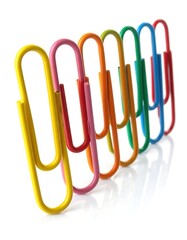 Colorful paperclips in a row against a white background