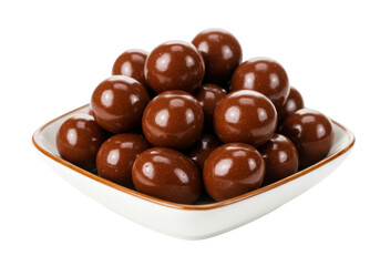 Isolated chocolates in a square bowl, coated in brown caramel, chocolate candy indulgence