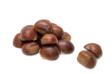 Stack of raw chestnuts isolated on white background, minimalist food concept. Organic vegetarian ingredient for autumn recipes and healthy eating