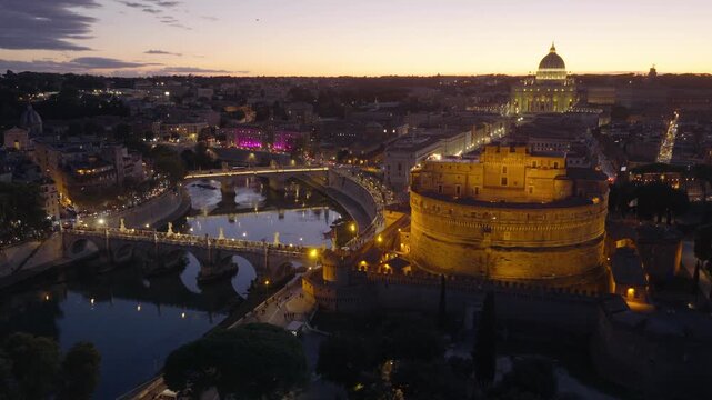 drone night view in Rome, Tiber river with Sant Angelo bridge and Castel Sant Angelo with night illumination, Rome is the capital of Italy, travel destination in Italy