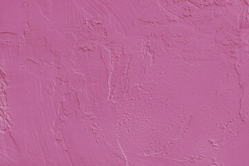 Close up, macro of pink painted textured stucco wall with rough plaster, concrete surface texture. Abstract background, backdrop for design, wallpaper art or decoration projects.