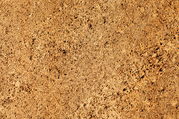 Weathered stone wall texture with rough, porous surfaces and natural brown tones, perfect for use as an architectural background or design element.