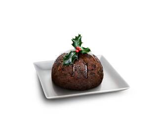 Looking down on a square white plate with a traditional Christmas pudding and sprig of holly on top isolated against a transparent background.