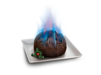 Looking down on a square plate with a sprig of holly and a traditional Christmas pudding soaked in brandy and lit giving blue flames isolated against a transparent background.