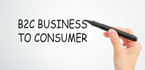 A hand is writing the word B2C Business to Consumer on a white background.