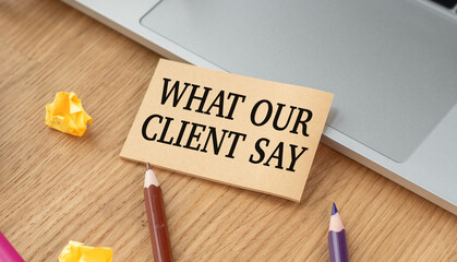 What our clients say. Text on tablet device on a wooden table
