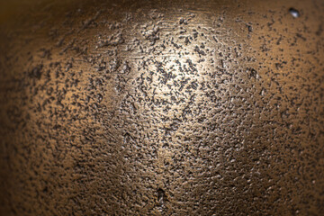 Golden background of an authentic image of an object, zoom on its texture for background and concept