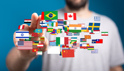 A person interacts with a vibrant collection of international flags, representing globalism, diversity, and interconnectedness. This image captu