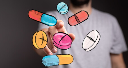 Stock photo of a hand interacting with colorful drawn pills, representing healthcare, medicine, or pharmacy.
