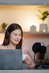 Podcasting. Young woman engaging in a lively discussion with a microphone setup.