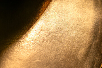 Fototapeta premium Golden background of an authentic image of an object, zoom on its texture for background and concept