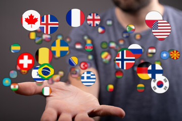 Person holding numerous country flags representing global connection, travel, unity, and international business or relationships.
