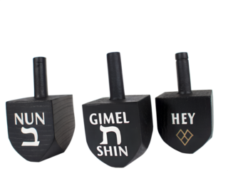 Three black dreidels with hebrew letters nun, gimel, shin, and hey isolated on transparent background