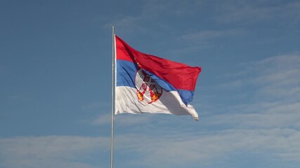 Serbian flag waving in the wind on clear day