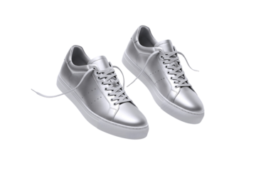 Pair of shiny silver metallic sneakers with white laces and soles isolated on transparent background