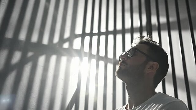 Man in contemplation behind bars