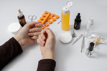 Woman has problems with her nails and she is going to rake care of it at the beauty salon. White manicure desk set and accessories on it
