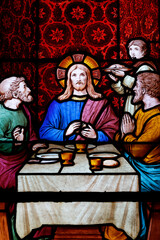 Fototapeta premium Saint Seine church. Stained glass. The Supper at Emmaus was one of the occasions when Jesus revealed himself to his followers after his Crucifixion and Resurrection. Corbigny. France.