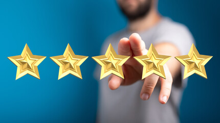 A person's hand pointing towards five golden stars representing a positive rating, feedback, or review. Perfect for concepts of success, achieve
