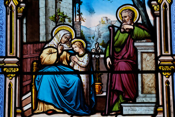 Fototapeta premium Saint Seine church. Stained glass. Saint Anne teaching the young Virgin how to pray. Corbigny. France.