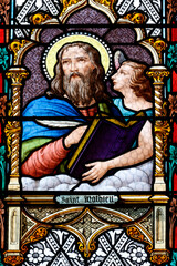 Fototapeta premium Saint Laurent church. Stained glass. Matthew is often symbolized by an angel, representing his focus on the humanity of Christ and the lineage of Jesus.. Tavernay. France.