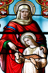 Fototapeta premium Saint Laurent church. Stained glass. The education of Mary by her mother St Anna. Tavernay. France.