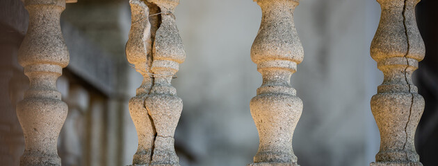 Cracked stone balusters on an old staircase
