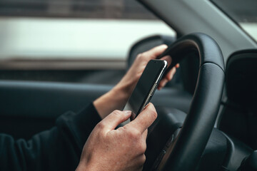 Irresponsible female driver using mobile phone while driving through city streets.