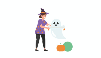 Woman in witch hat decorates for Halloween with a friendly ghost pumpkin and festive ribbon