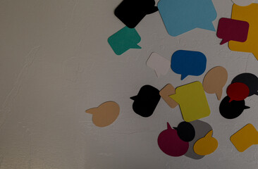 A vibrant arrangement of assorted colored speech bubbles against a textured gray background. Great...