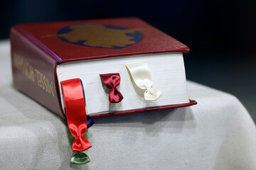 Catholic mass in a church. Roman missel on altar.  Bonneville. France.