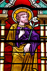 Fototapeta premium Bayeux cathedral. Stained glass. Saint Joseph holding a lily, symbolizing purity, integrity, and his role as the protector of the Holy Family. Bayeux. France.
